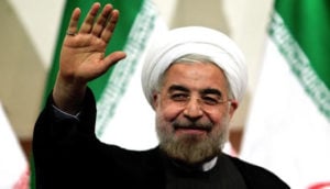 Photo of Iranian President Hassan Rowhani with his hand raised in greeting