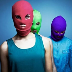 3 people wearing colored cloth masks that cover their entire heads