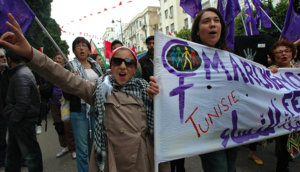 Woman behind a banner during a protest in Tunisia
